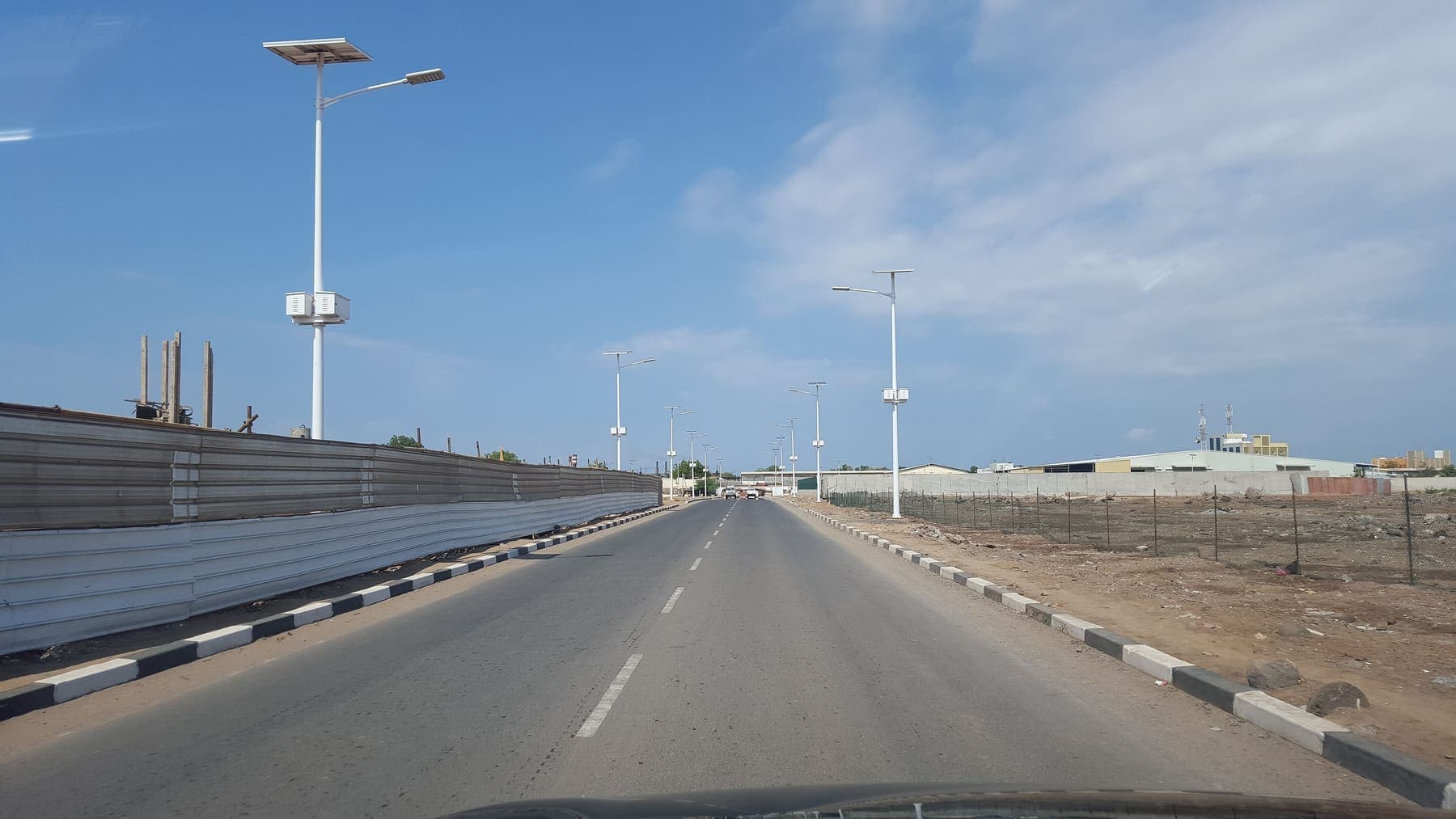 Paved road with street lighting through the Haramous district