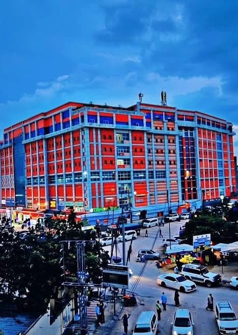 The full length of the building at dusk, seen across Road No. 1
