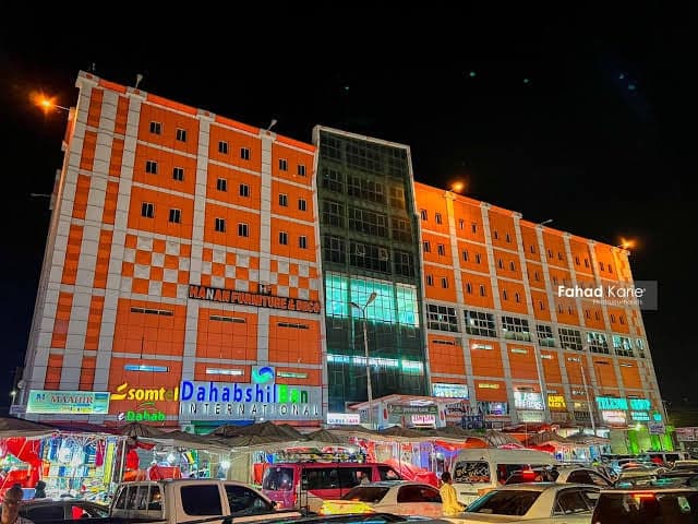 The theatre business centre lit up at night above the evening market