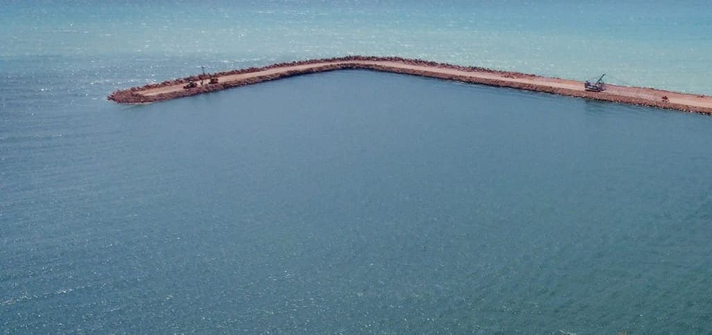 Rock breakwater under construction in open sea