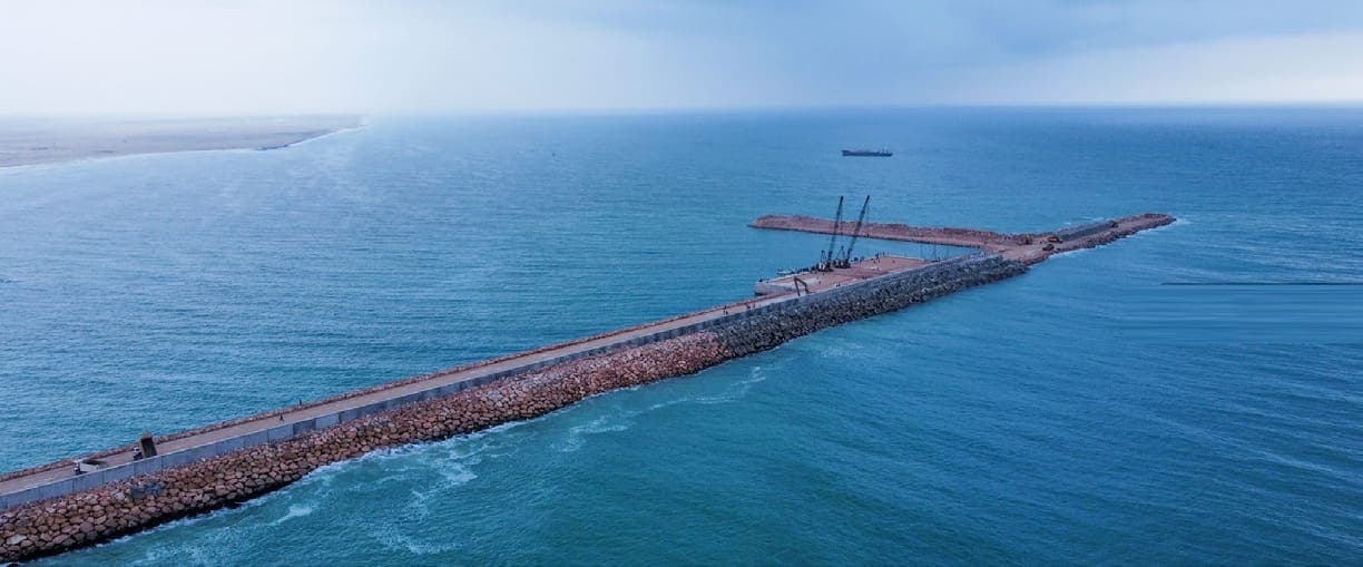 Concrete quay and rock breakwater of Garacad Seaport seen from the air